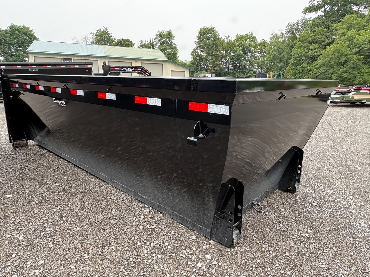 Side view of a black dumpster container